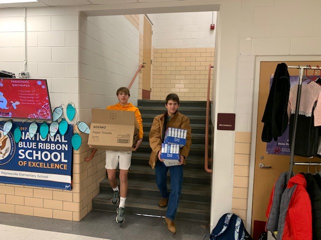 two people holding boxes